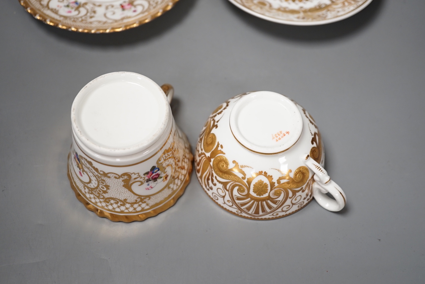 A Chamberlains Worcester gadroon bordered coffee cup and saucer painted with flowers, printed mark in puce and a Spode teacup and saucer with raised gilding in neo-classical style pattern 4327, mark and pattern in red